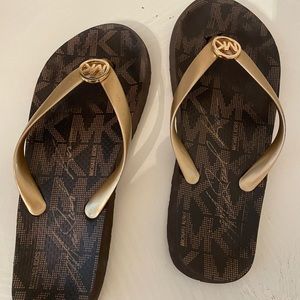 Metallic gold MK flip flops-